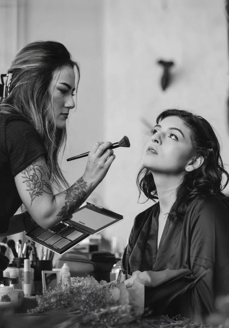 Chelsea applying bridal makeup — Harvest Glam bridal makeup artist Seattle